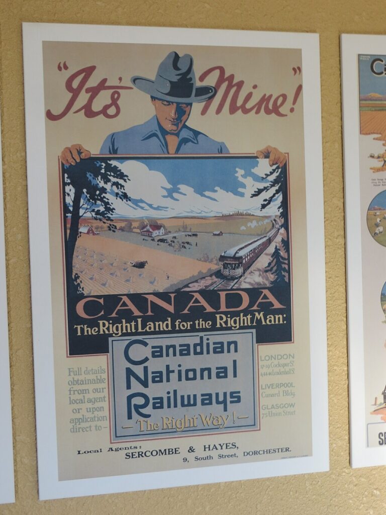 A poster advertising land in Canada. A figure of a man holds a poster of a rural landscape. The test reads:
"It's Mine!"
Canada: The Right Land for the Right Man
Canadian National Railways
The Right Way!