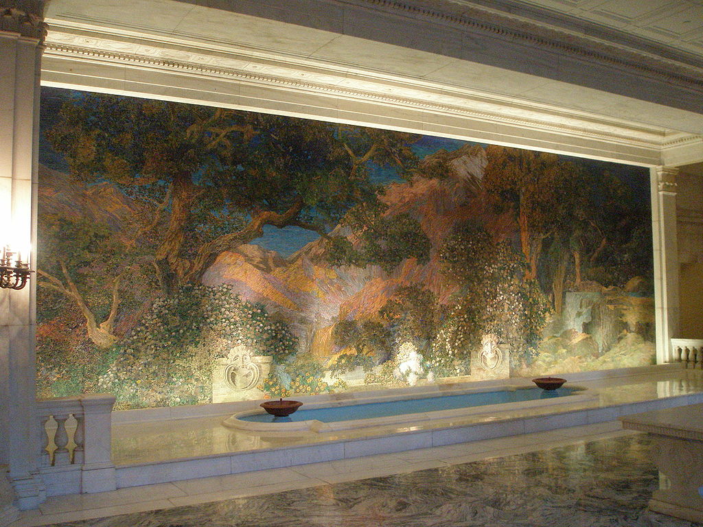 A mural is set within a marble recess. It is the height of the ceiling and three times as long. It features trees, mountains, with Greco-Roman statuary in the foreground.