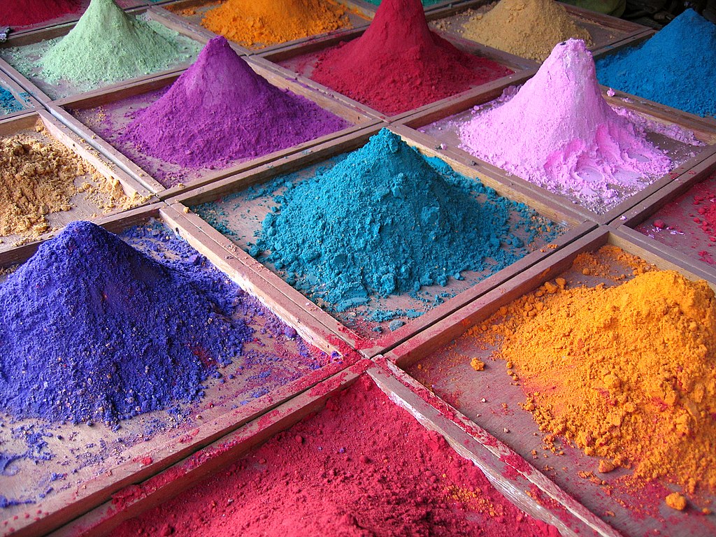 Piles of multi-coloured ground pigments on sale in a market stall. 