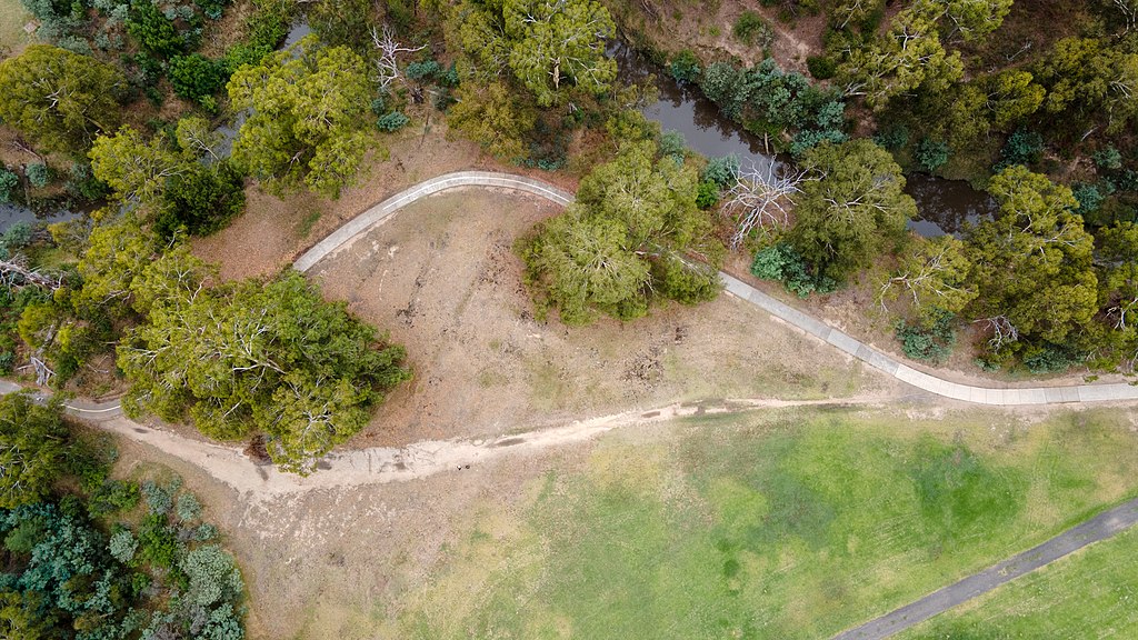 An aerial photo of meandering pathway and the more direct desire path that has been created beside it. 