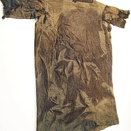 A brown, coarsely woven shirt that is torn and frayed at the sleeves.