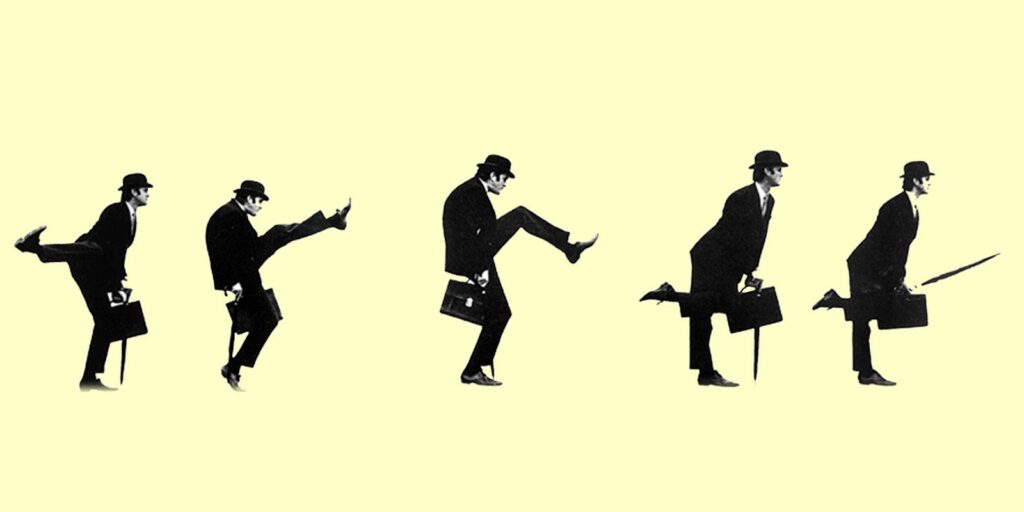 A male figure wearing a bowler hat and carrying a briefcase and an umbrella is shown doing a series of silly walks. 
